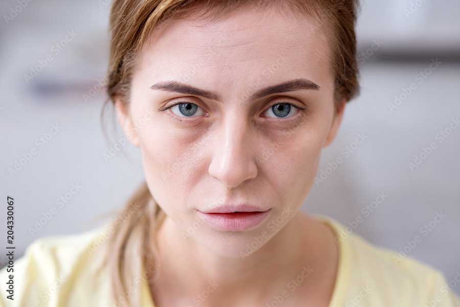 2407 Portrait of a pale exhausted woman looking at you while being ill.jpg