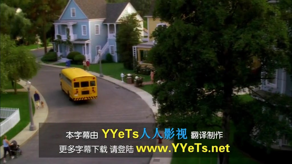 A school bus is driving up the road.jpg