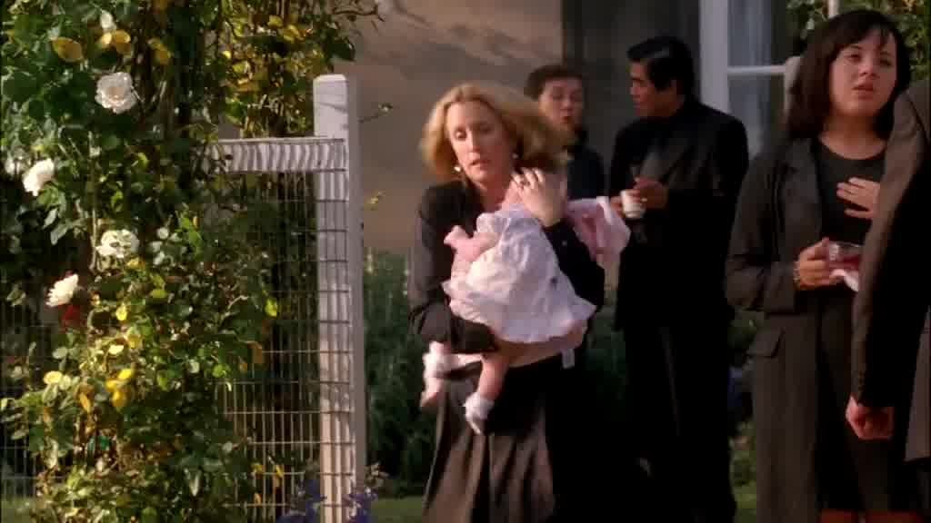 LYNETTE hurries down the path to the  poolside holding the baby.jpg