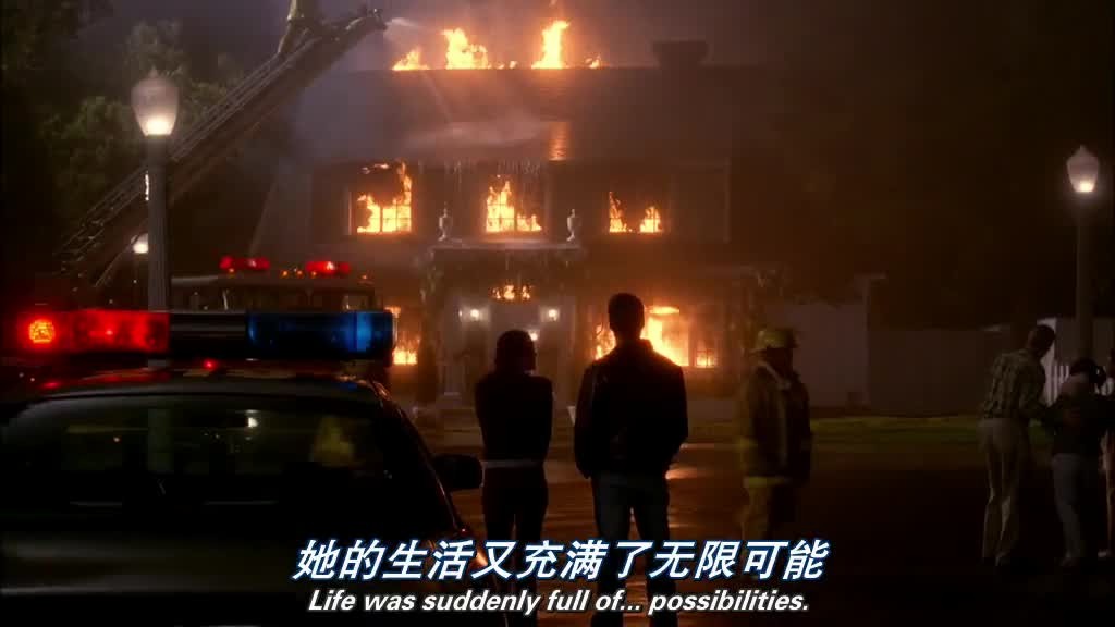 SUSAN smiles, looking back at the burning house.jpg