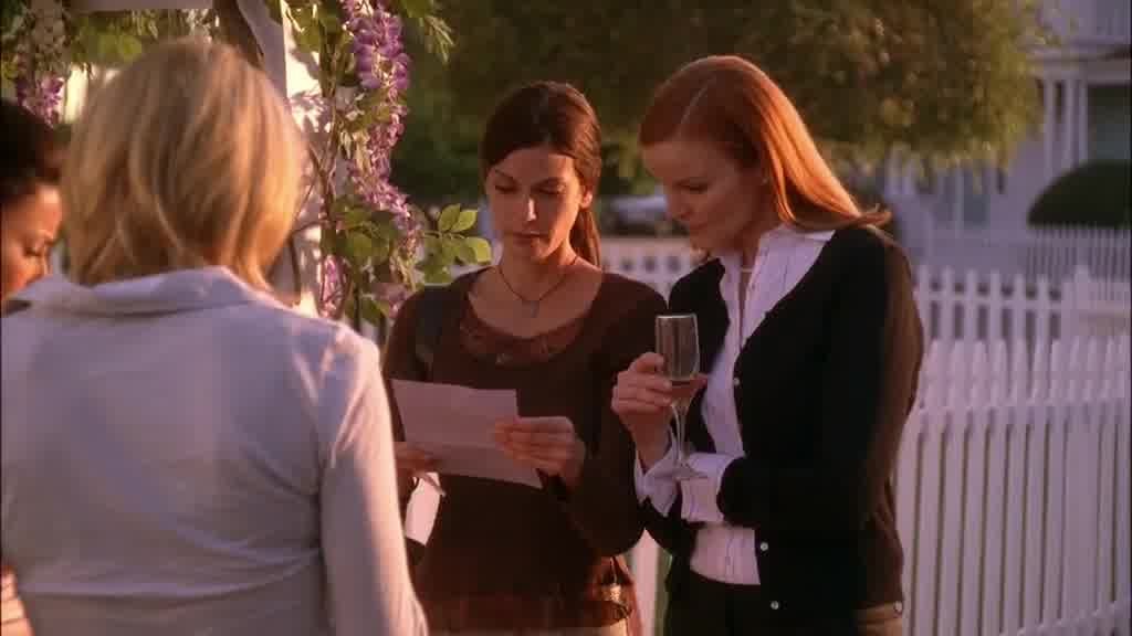 They pass it to SUSAN, who reads the note with BREE looking over her shoulder.jpg