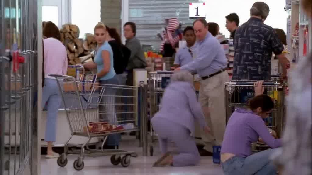 A cart comes out of an aisle behind LYNETTE and bumps into an elderly lady, who .jpg