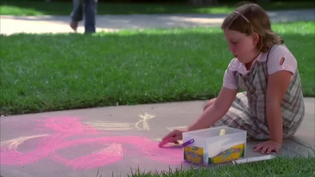 ASHLEY is sitting on the sidewalk, drawing with chalk on the sidewalk as GABRIEL.jpg