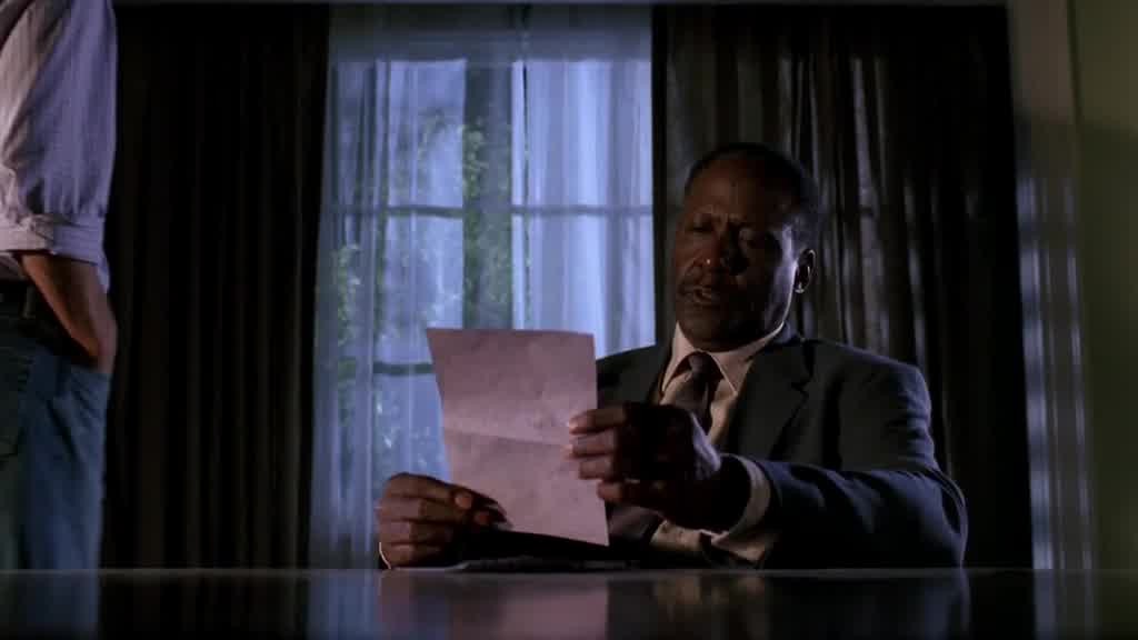 A private investigator sits at Paul's table reading the note.jpg