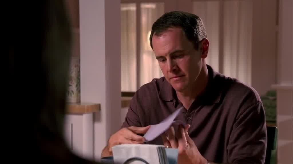 He pulls the letter out of the envelope and reads the note.jpg