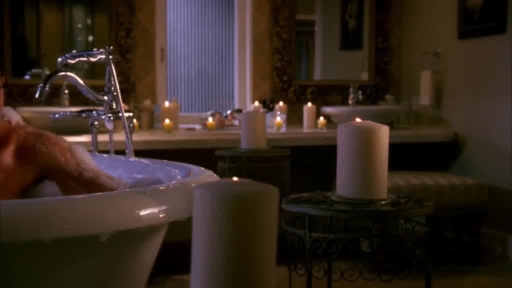 It's dark in the bathroom, the only light coming from the many candles in t.jpg