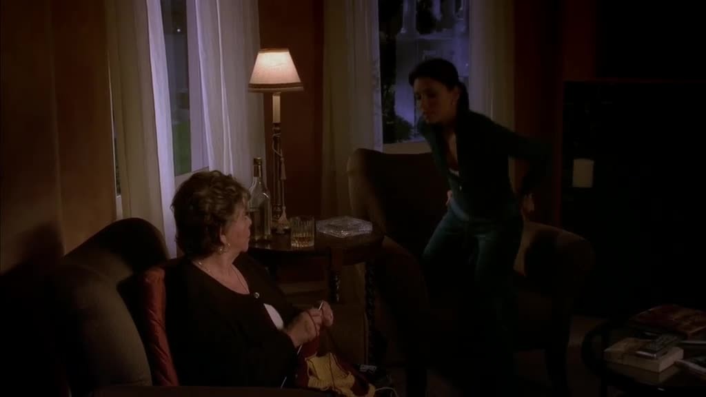 Gabrielle grudgingly sits down with her mother in law.jpg