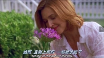 S01E01 She kneels in front of her flowerbed, and smells a flower, smilling faintly