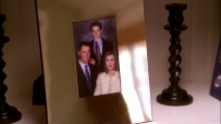 S01E01 The blurred reflection of MARY ALICE is shown in the frame of the picture falling to the ground